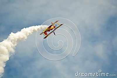 Airplane doing Tricks with Blue Sky Background Editorial Stock Photo
