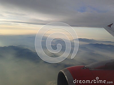Airplane engine wing with stunning mountains and sky background Stock Photo