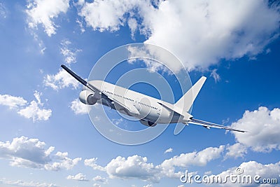 An airplane flying in the blue sky Stock Photo