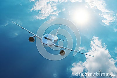 Airplane flying in blue sky with clouds. Travel and transportation concept Stock Photo