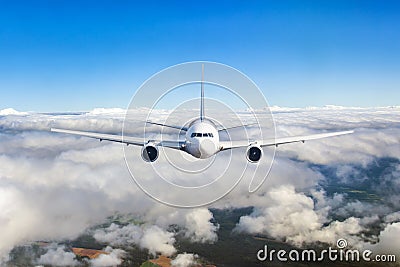 Airplane flying in the clouds. Front view aircraft Stock Photo