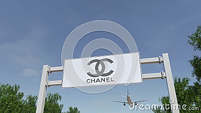 Airplane flying over advertising billboard with Chanel logo. Editorial 3D rendering Editorial Stock Photo