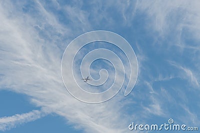 Airplane flying through scenic clouds in Orange County, California Stock Photo