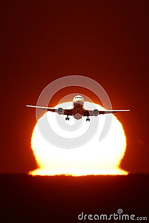 An airplane flying in the sun Stock Photo