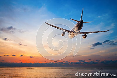 Airplane flying at sunset Stock Photo