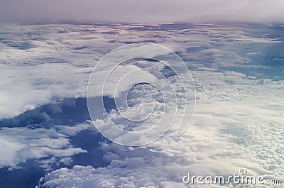 Airplane illuminator view on fluffy clouds and blue sky. Stock Photo