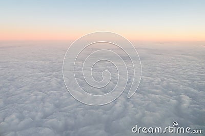 Airplane illuminator view on fluffy clouds and sunrise sky. Clouds view from the aircraft illuminator Stock Photo