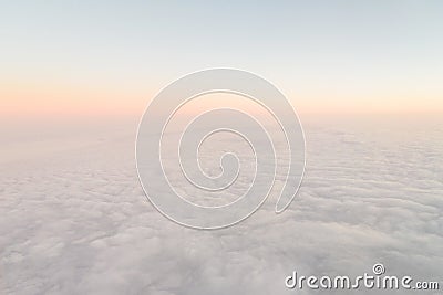 Airplane illuminator view on fluffy clouds and sunrise sky. Clouds view from the aircraft illuminator Stock Photo