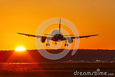 Airplane landing flying airport sun sunset vacation holidays travel traveling plane Stock Photo