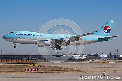 Airplane landing on a runway against a blue sky in Tianjin, China Editorial Stock Photo