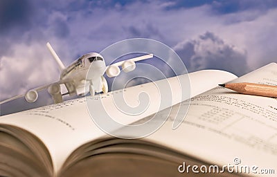 Airplane model on textbook or hardback. The concept of tourism Stock Photo