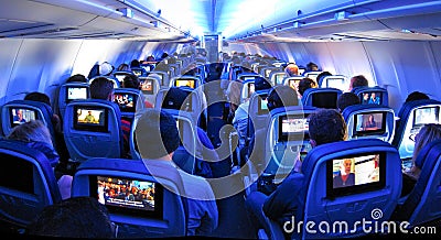 Airplane Passengers, Seats and TV screens Editorial Stock Photo