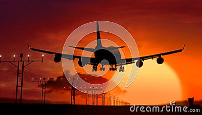 Airplane silhouette landing on sunset Stock Photo