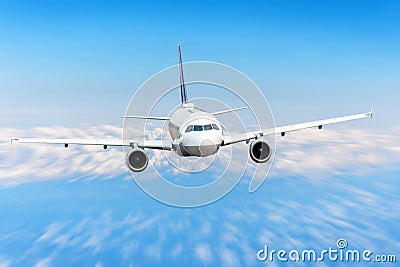 Airplane in the sky above the clouds flight journey sun height speed motion blur. Passenger commercial aircraft. Stock Photo