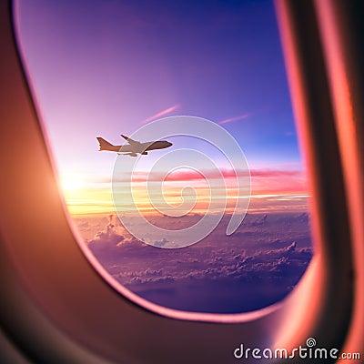 Airplane in the sky at sunrise Stock Photo