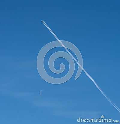 Airplane soaring through the clear blue sky, leaving behind long white contrails in their wake Stock Photo