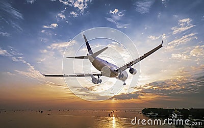 Airplane in the sunset sky flight travel transport Stock Photo