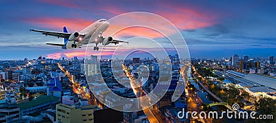 Airplane take off over the panorama city at twilight scene Stock Photo