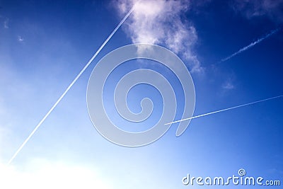 Airplane trails on blue sky Stock Photo