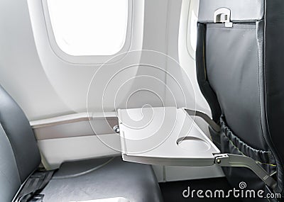 Airplane tray table on seat back . Stock Photo