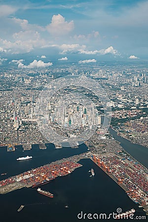 Airplane view of the City of Manila. Capital of Philippines from above. Manila bay, ships, port, Pasig River, buildings below. Stock Photo