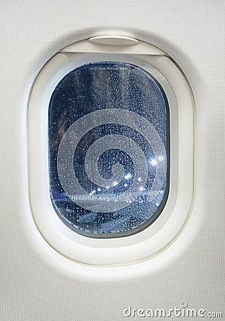 Airplane window view at night with raindrop Stock Photo