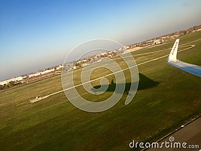 Airplane wing and shadow at take off Editorial Stock Photo