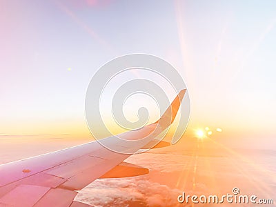 Airplane wing in the sky at beautiful sunset, airplane flight in the sky with copy space Stock Photo