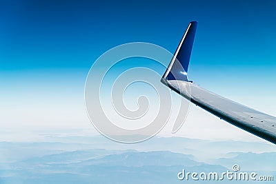 Airplane Wing View Above Clouds Stock Photo