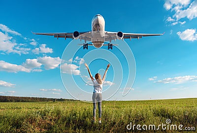 Airplane and woman on the field at sunset in summer Stock Photo