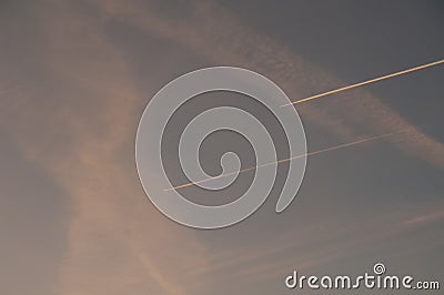 Airplanes and contrails of another airplanes in the sky. Stock Photo