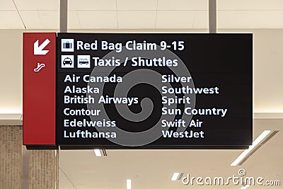 Airport Baggage Claim and Taxi Shuttle Sign Editorial Stock Photo
