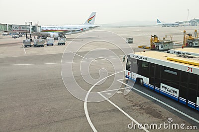 Airport bus next to gangway and airplane Editorial Stock Photo
