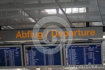 Airport flight information on a large screen international departure board Editorial Stock Photo