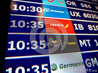 Airport information board close-up in modern Spanish Europe Airp Editorial Stock Photo