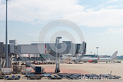 Airport jetway and airplane Stock Photo