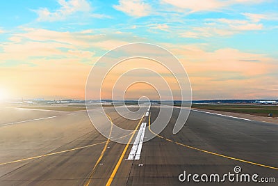 Airport runway after sunset horizon and picturesque cirrus clouds in the sky. Stock Photo