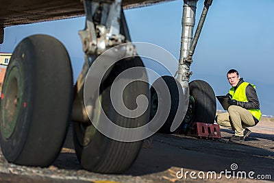 Airport worker checking chassis Stock Photo