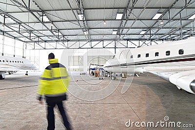 Airport workers check an aircraft for safety in a hangar Stock Photo