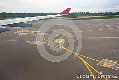 Airport yellow taxiway lines markings on the apron on concrete asphalt, sign for airplane pilots Stock Photo