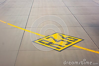 Airport yellow taxiway lines R36 markings on the apron on concrete asphalt, sign for airplane pilots Stock Photo