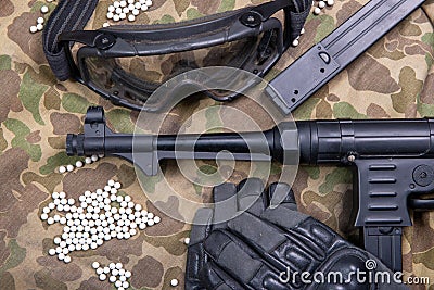 Airsoft gun with protective glasses and lot of bullets Stock Photo