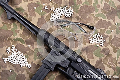 Airsoft gun with protective glasses and lot of bullets Stock Photo