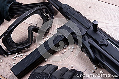 Airsoft gun with protective glasses and lot of bullets Stock Photo