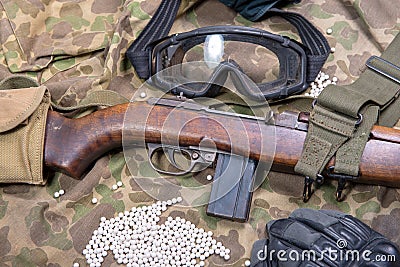 Airsoft gun with protective glasses and lot of bullets Stock Photo