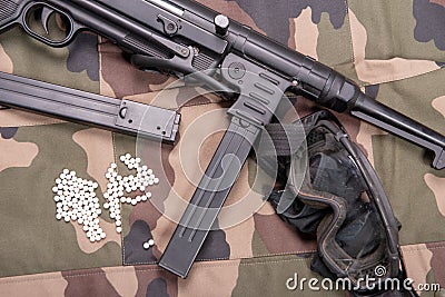 Airsoft gun with protective glasses and lot of bullets Stock Photo