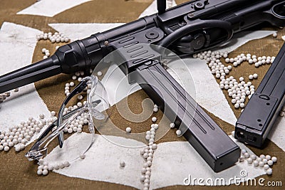 Airsoft gun with protective glasses and lot of bullets Stock Photo