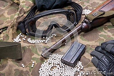 Airsoft gun with protective glasses and lot of bullets Stock Photo