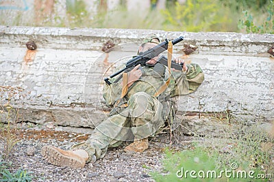 Airsoft player reloads his weapon during a firefight. Stock Photo