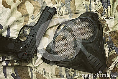 Airsoft protection mask, Terrorist mask and 9mm pistol. Stock Photo